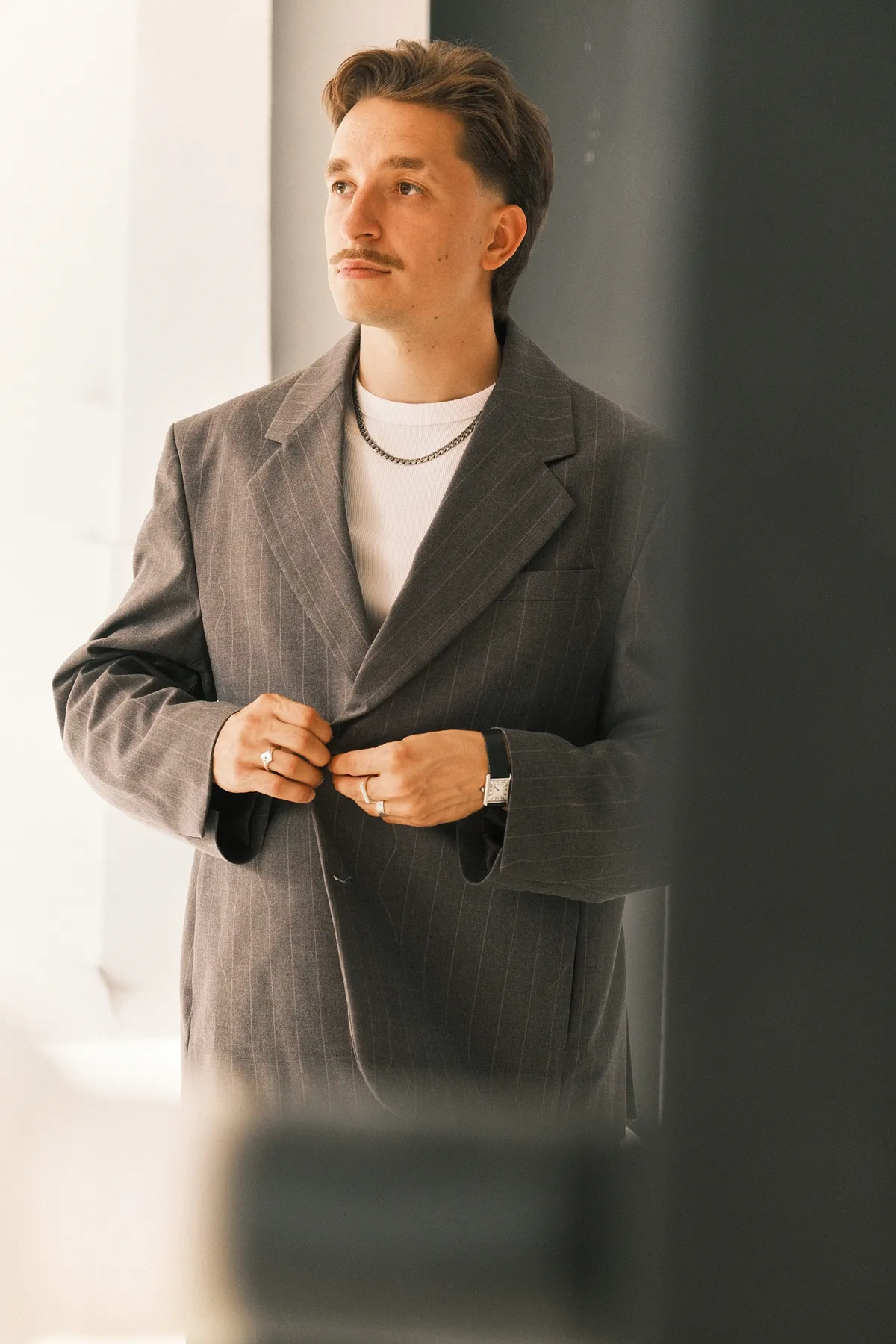 Professional portrait of Ernestas in a stylish pinstripe blazer